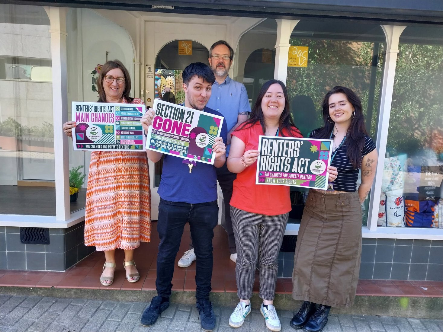 Accommodation Concern team holding Renters' Rights Act information posters outside the office