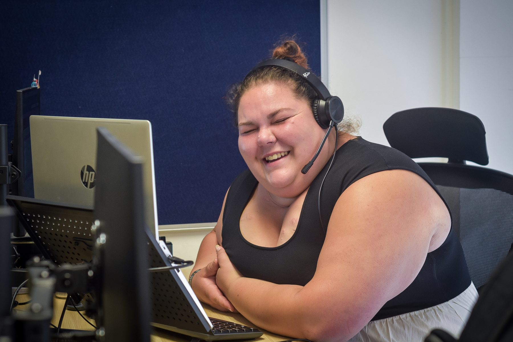 Accommodation Concern adviser smiling while working at a computer